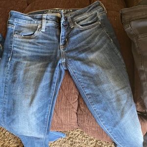 American Eagle jeggings black and blue jeans- good condition-